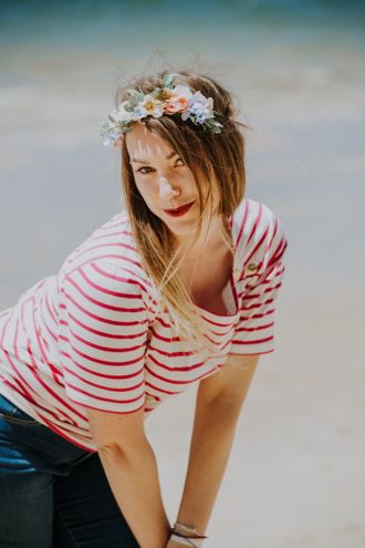 Bride-to-be in red striped shirt posing on the beach during her bachelorette party in Arcachon in Landes region