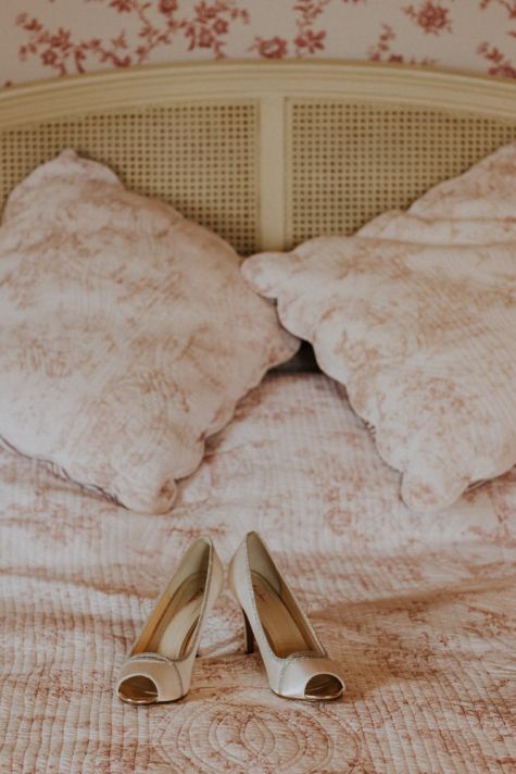 Chaussures de mariée sur le lit au chateau de la Cote pour un mariage anglais en Périgord